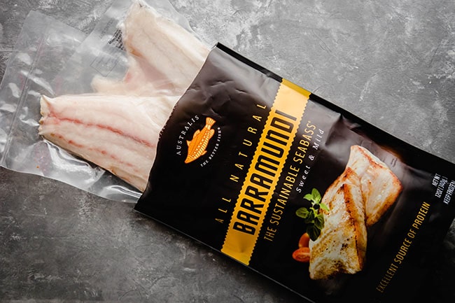 A bag of Australis barramundi on a grey background.