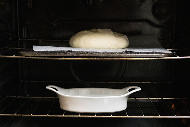 Bread dough baking on a baking steel in the oven.