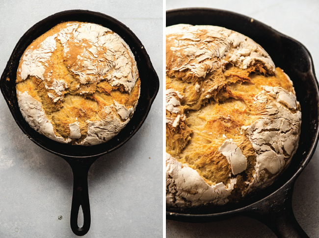 Loaf of crusty bread in a cast iron skillet.