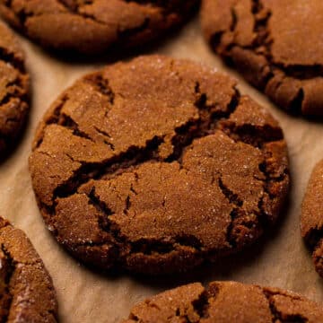 Gingersnaps on a baking sheet lined with parchment paper.