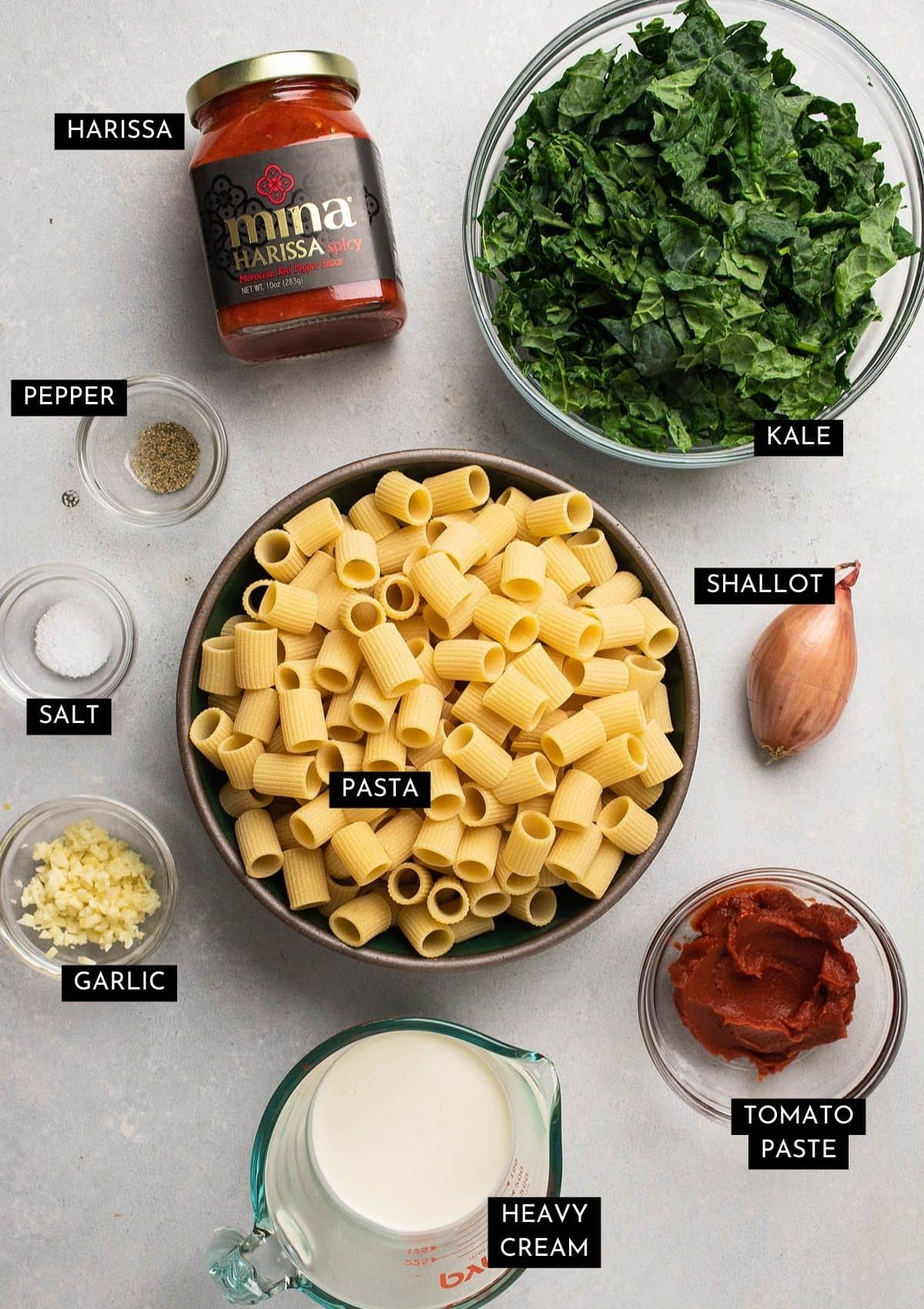 Harissa pasta ingredients on a white table.