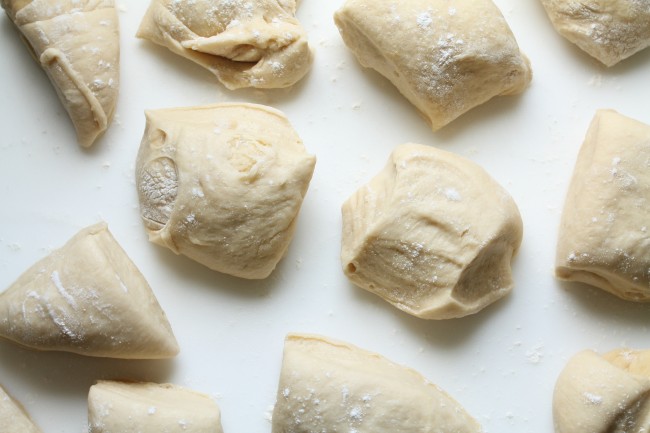 Several pieces of challah dough cut into evenly-sized squares.