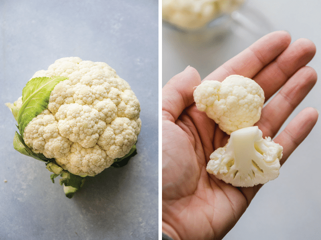 Woman\'s hand holding two cauliflower florets.