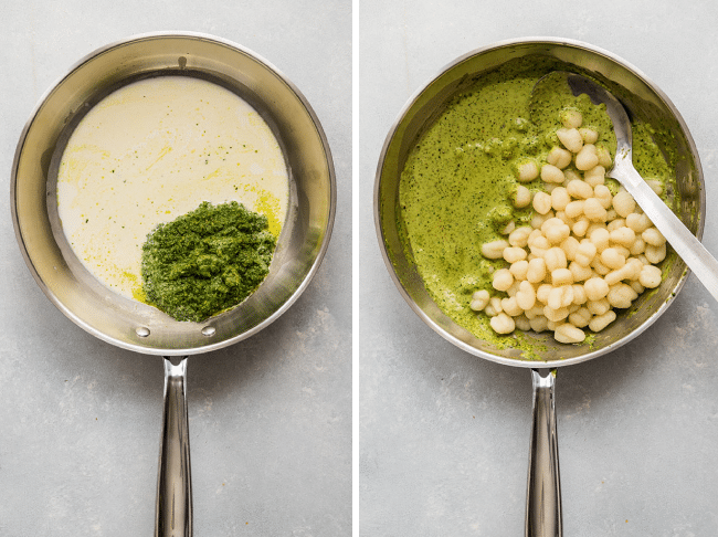 Gnocchi, pesto, and heavy cream being stirred together in a skillet.