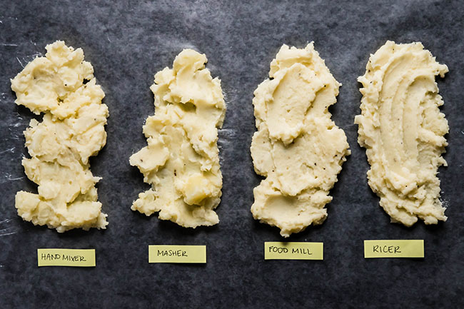 Four scoops of mashed potatoes, each spread over a piece of waxed paper to show texture. Labels indicate which method was used: ricer, masher, food mill, ricer.