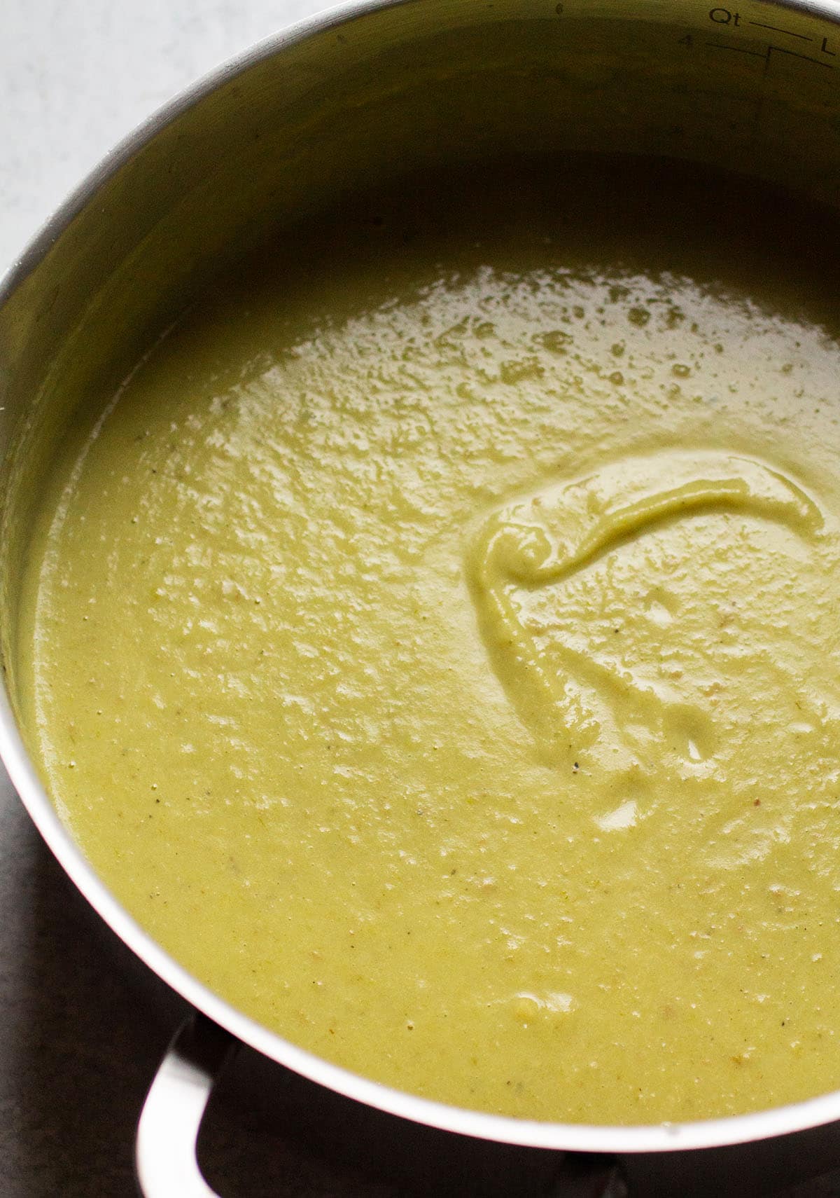 Leek and potato soup in a large silver saucepan.