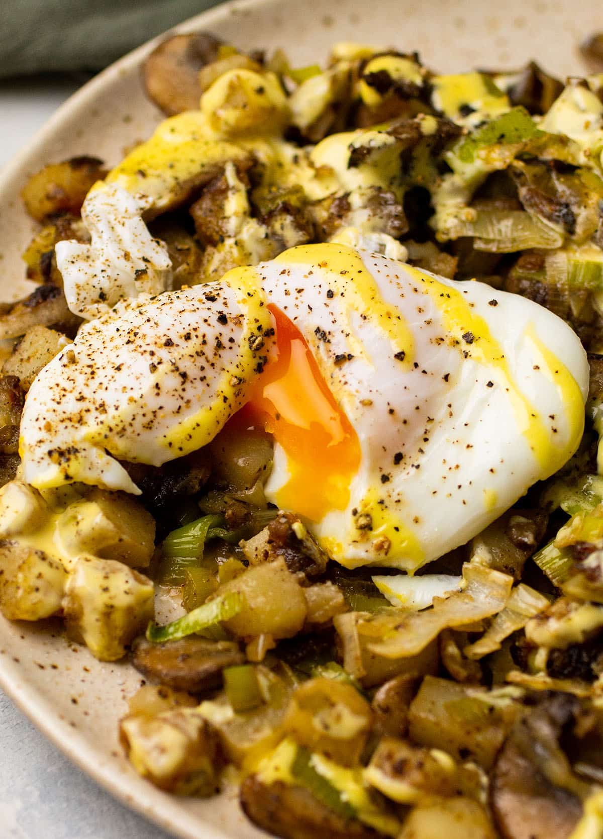 Poached egg with runny yolk on top of mushroom hash.