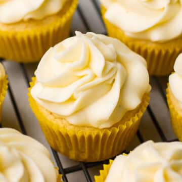 Lemon cupcakes with frosting on a wire cooling rack.