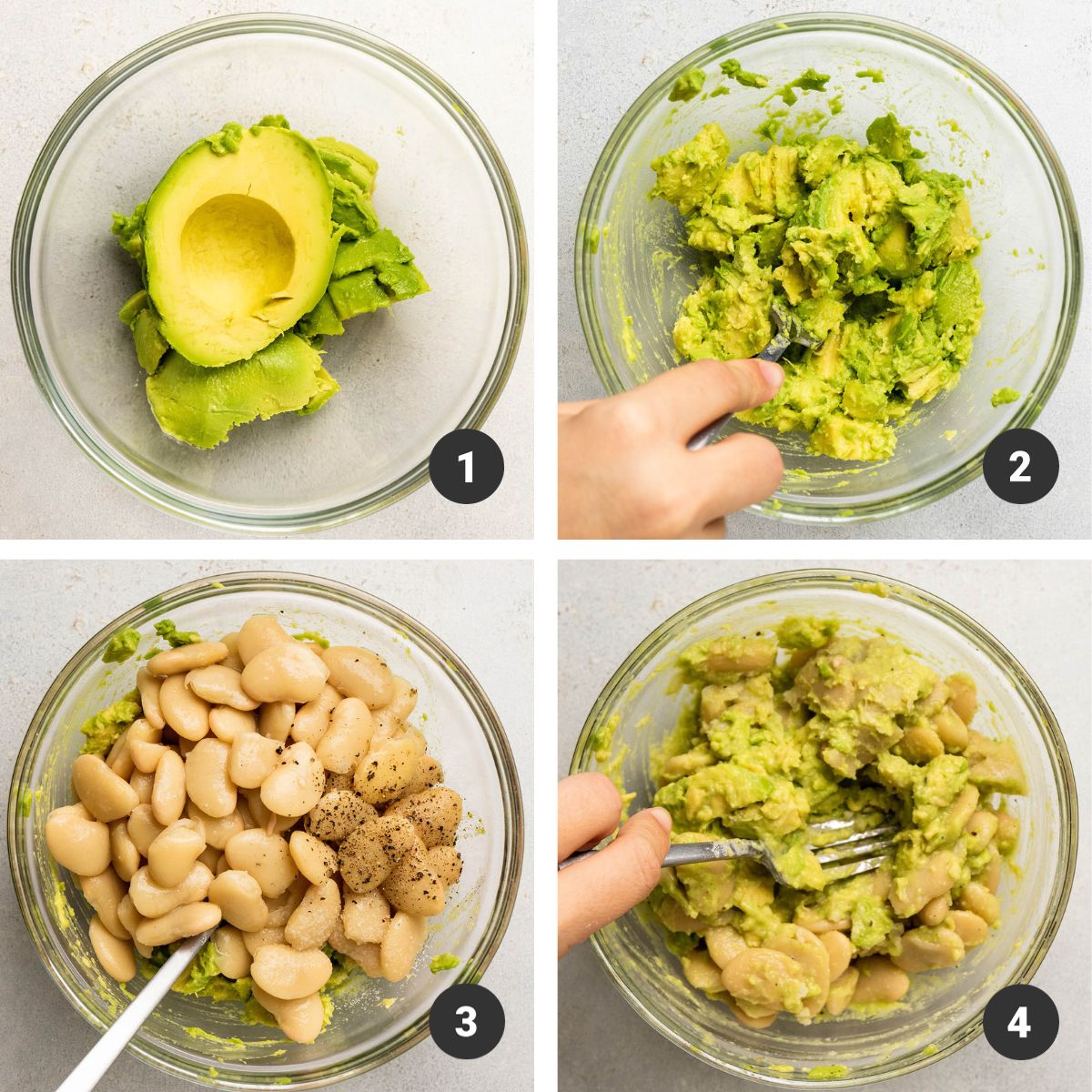 Mashing avocado with butter beans in a glass bowl.