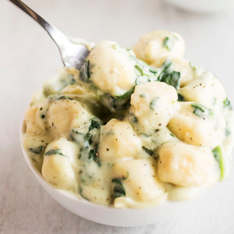 Gnocchi in white cream sauce with spinach.