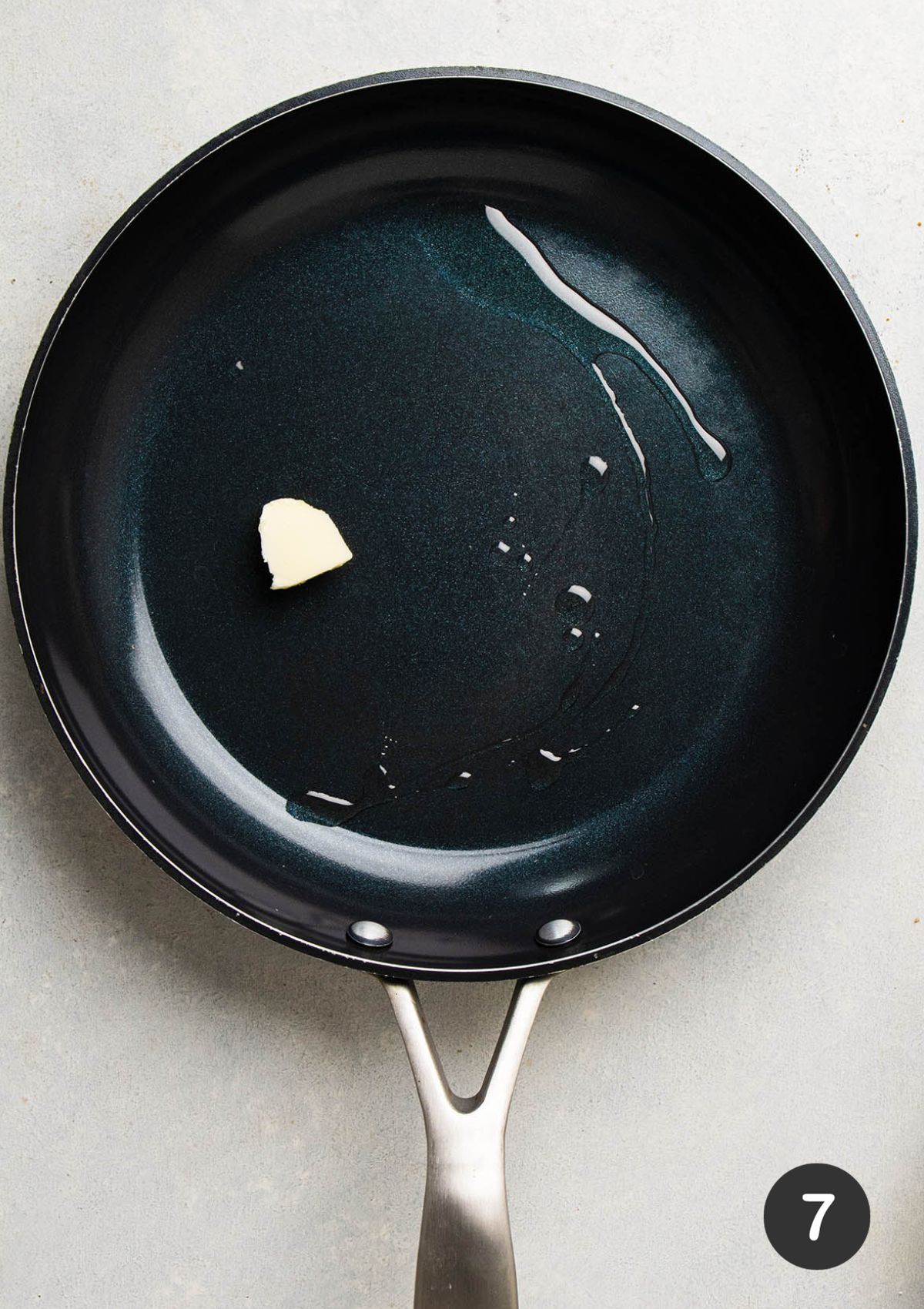 Melting butter in a large skillet with a drizzle of grapeseed oil.