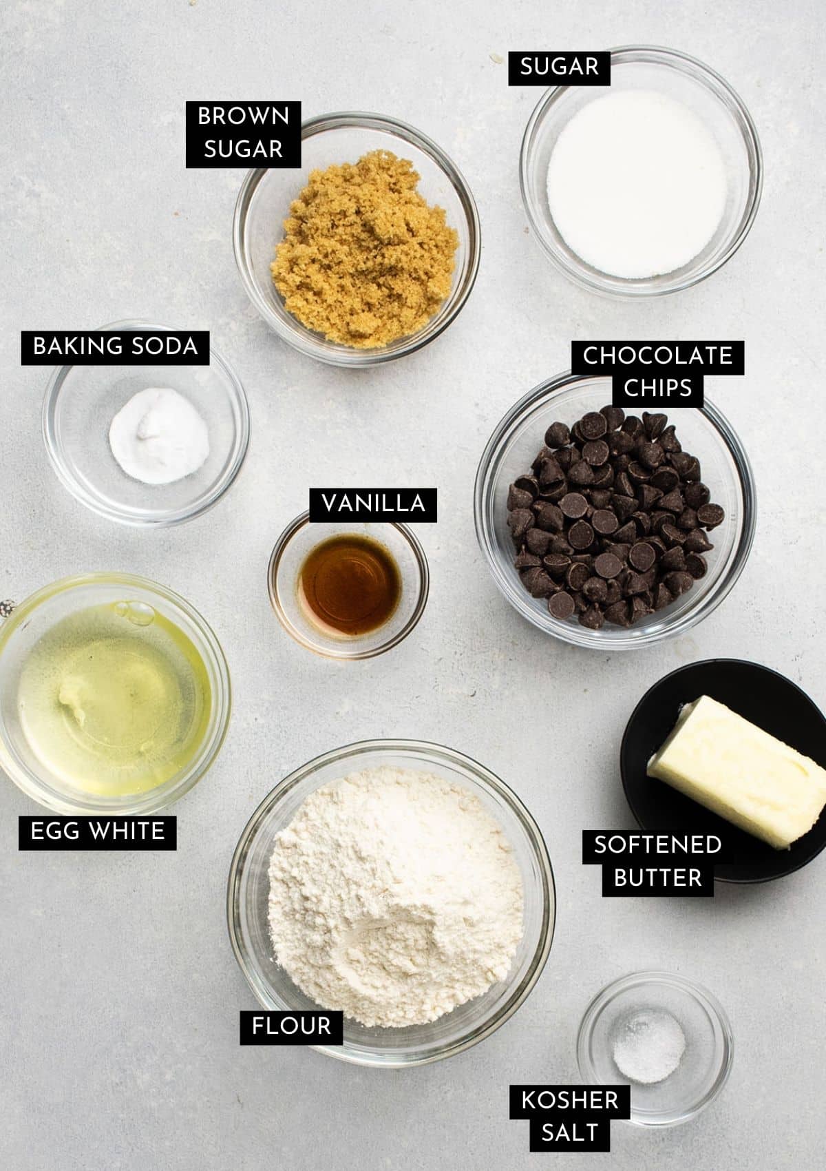 Small batch cookie ingredients, organized into individual bowls on a white table.