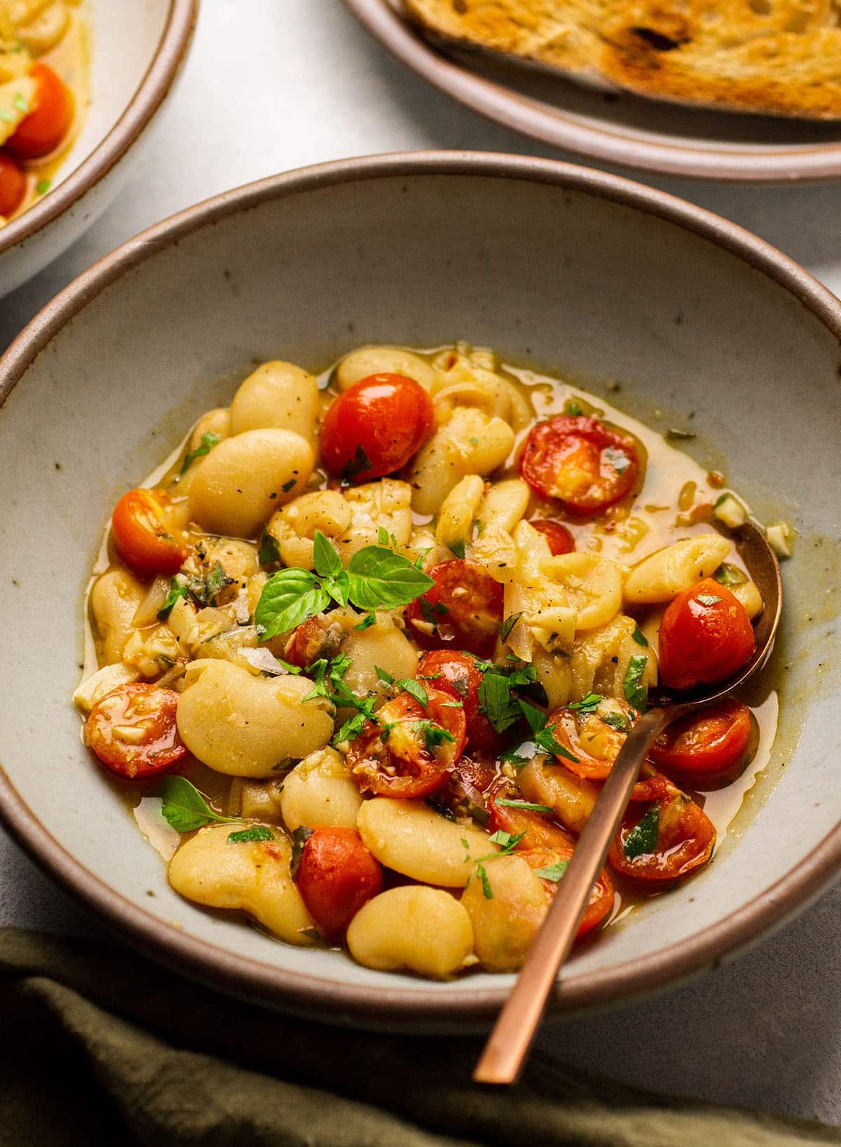 Butter beans with broth and tomatoes.