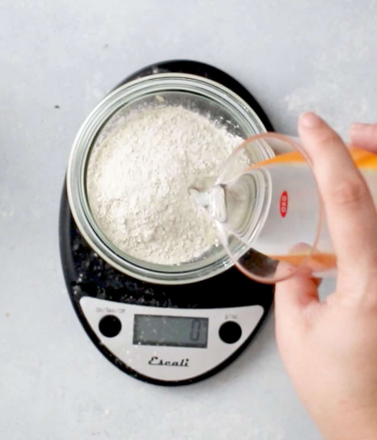 Measuring ingredients with a black kitchen scale.
